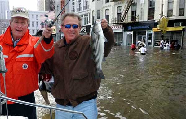 Photo of George and George fishing in 'Nawlins'  during Katrina.  With smiles on their faces, Sr. holds the rod and Jr. holds the fish on a boat, while African Americans, in the background, wade through the flooded streets. (Spoof) 