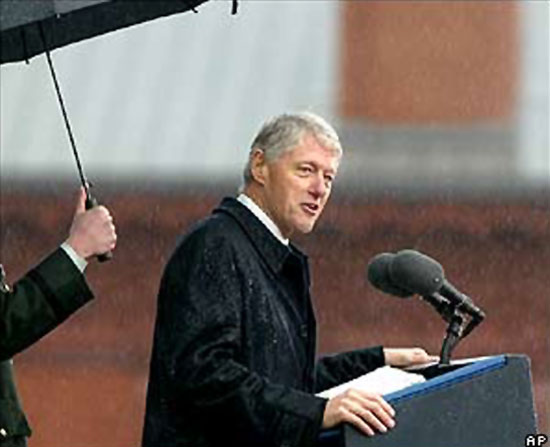 Clinton giving speech in rain